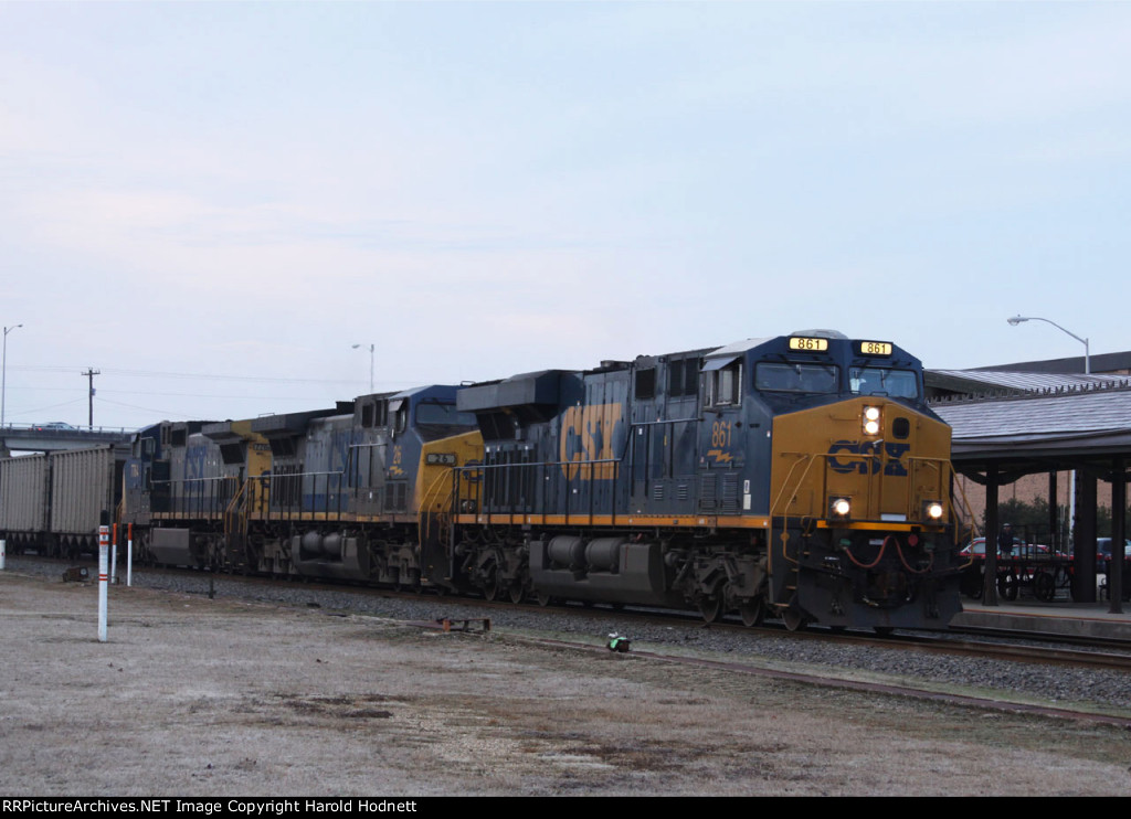 CSX 861 leads a coal train past the station on a dreary morning